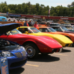 A row of cars parked at the Catch the Vision Car Show