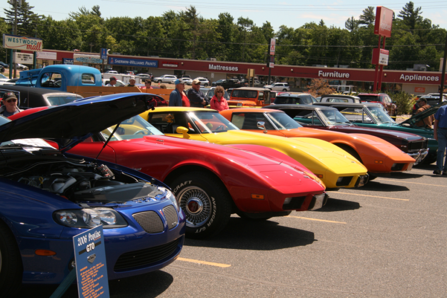 A row of cars parked at the Catch the Vision Car Show
