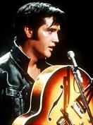 Elvis Presley on stage with his guitar